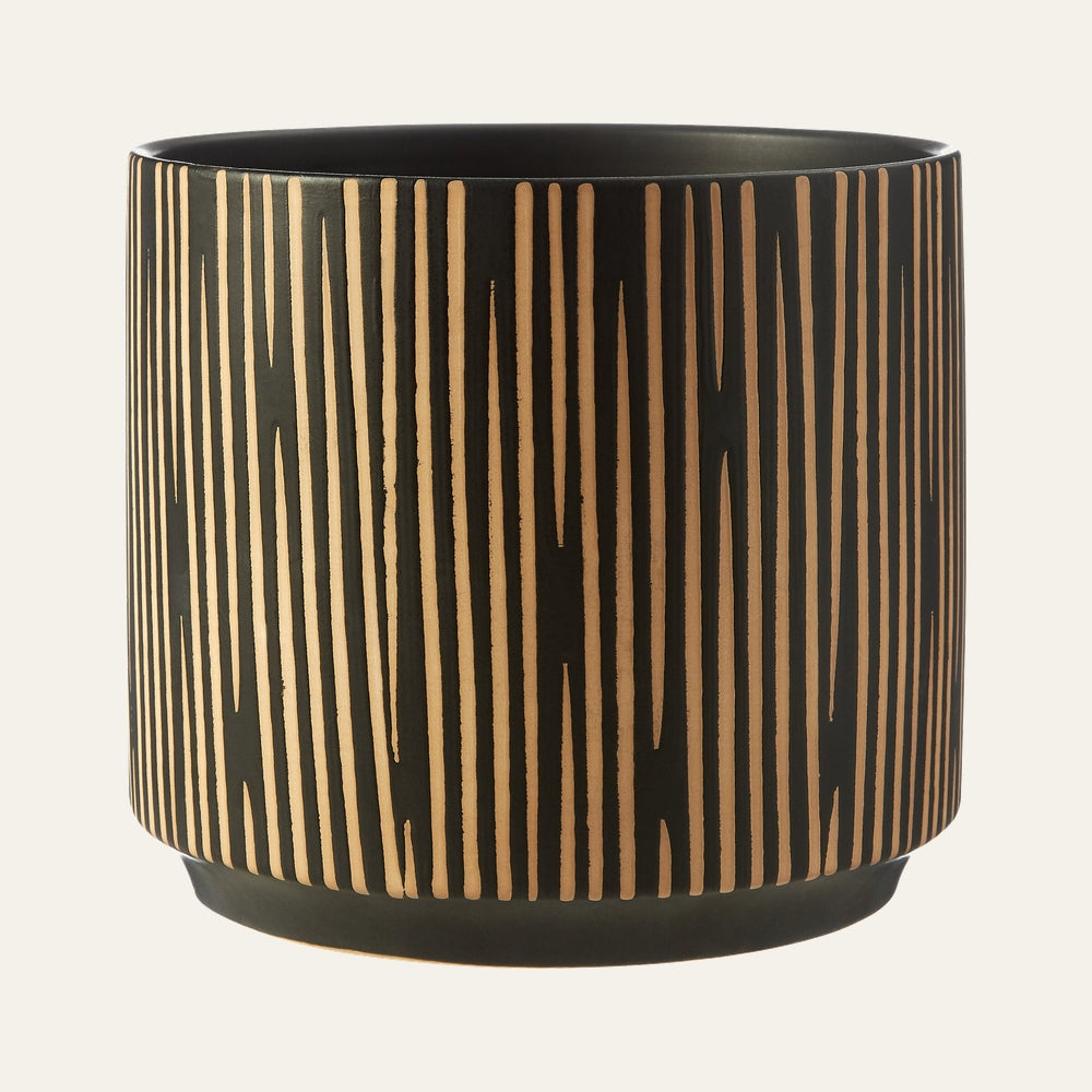 Eldan Ceramic Finish Planter — cylindrical matte black ceramic planter with vertical carved tan clay stripes and a low rounded base