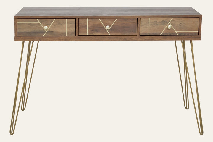 Elian Three Drawer Desk with rectangular warm wood-grain top, three front drawers with brass geometric inlay and round brass knobs, supported by brass hairpin legs