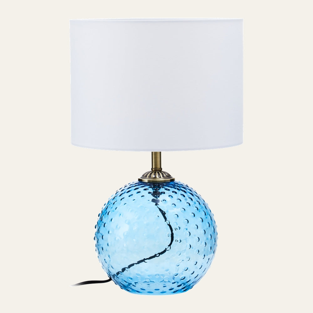 Elivella Table Lamp with dimpled blue glass sphere base, brass-tone neck and white drum fabric shade