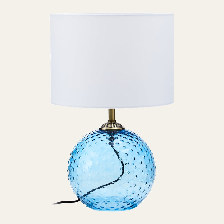 Elivella Table Lamp with dimpled blue glass sphere base, brass-tone neck and white drum fabric shade