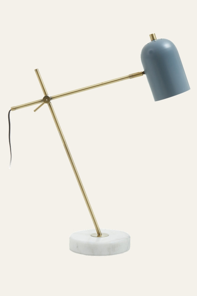 Elran Marble Desk Lamp — round white marble base, angled brass-finish metal arm and crossbar, blue metal dome shade and visible black power cord