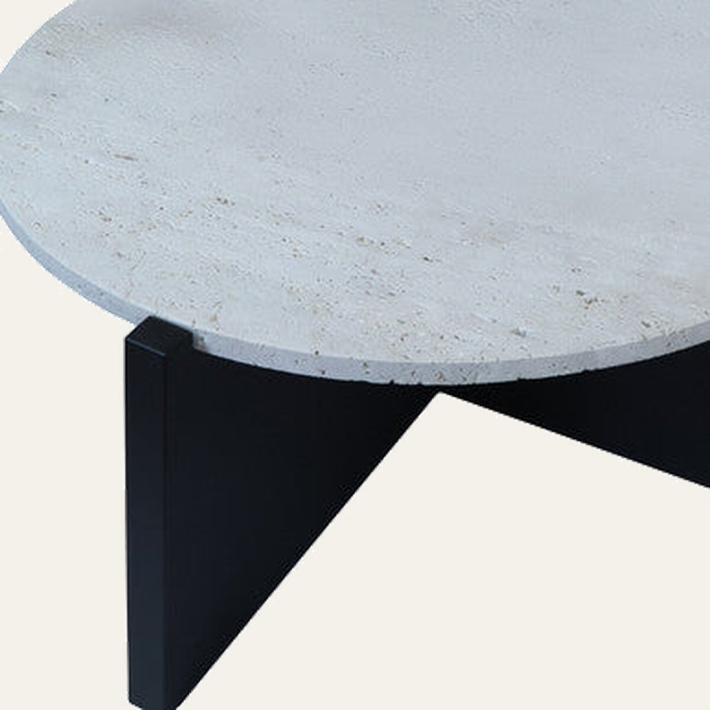 Elsen Travertine Coffee Table — close-up of round light beige travertine top with natural pores and subtle veining, resting on a black angular geometric base.