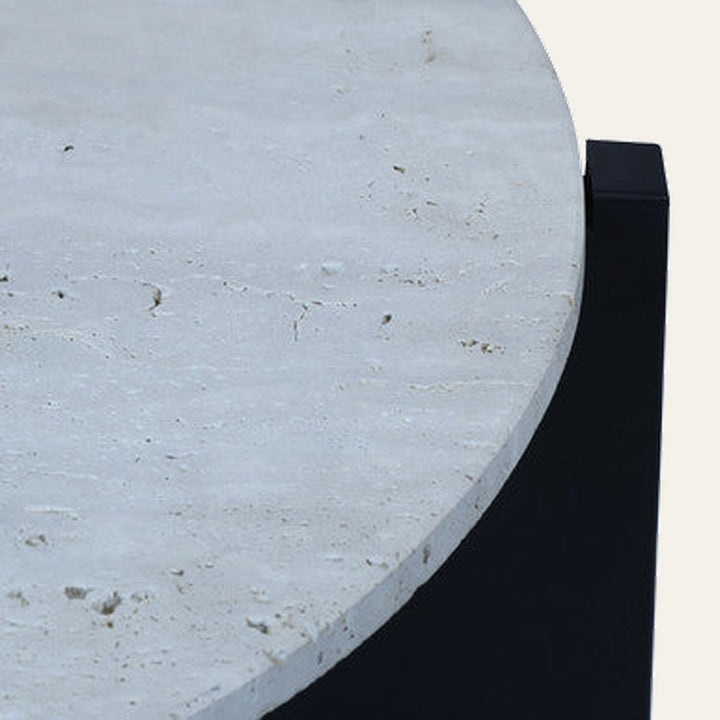 Elsen Travertine Coffee Table close-up of round light travertine tabletop with natural pitting and edge over a black rectangular base