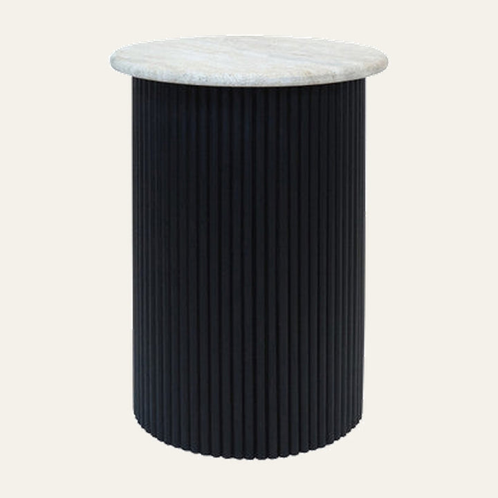 Elsen Travertine Side Table with round light travertine top and tall black fluted cylindrical base