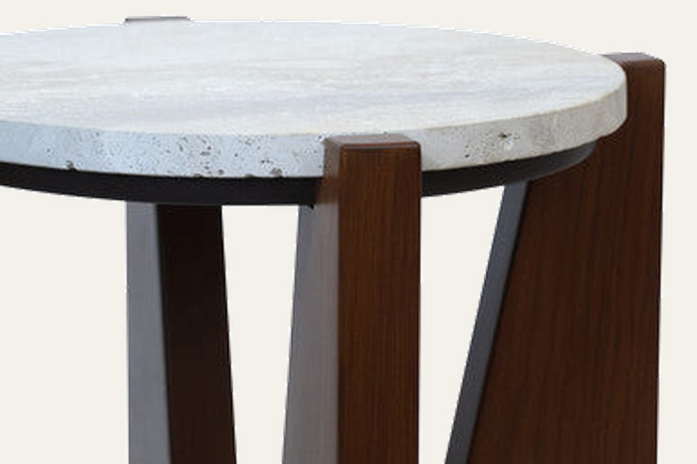 Elsen Travertine Side Table with round light travertine top, black metal rim, and angled dark wood legs