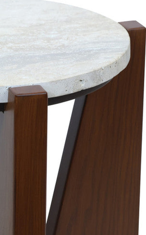 Elsen Travertine Side Table with round light travertine stone top showing natural veining and textured edge, supported by dark brown wooden triangular legs and a black support accent.