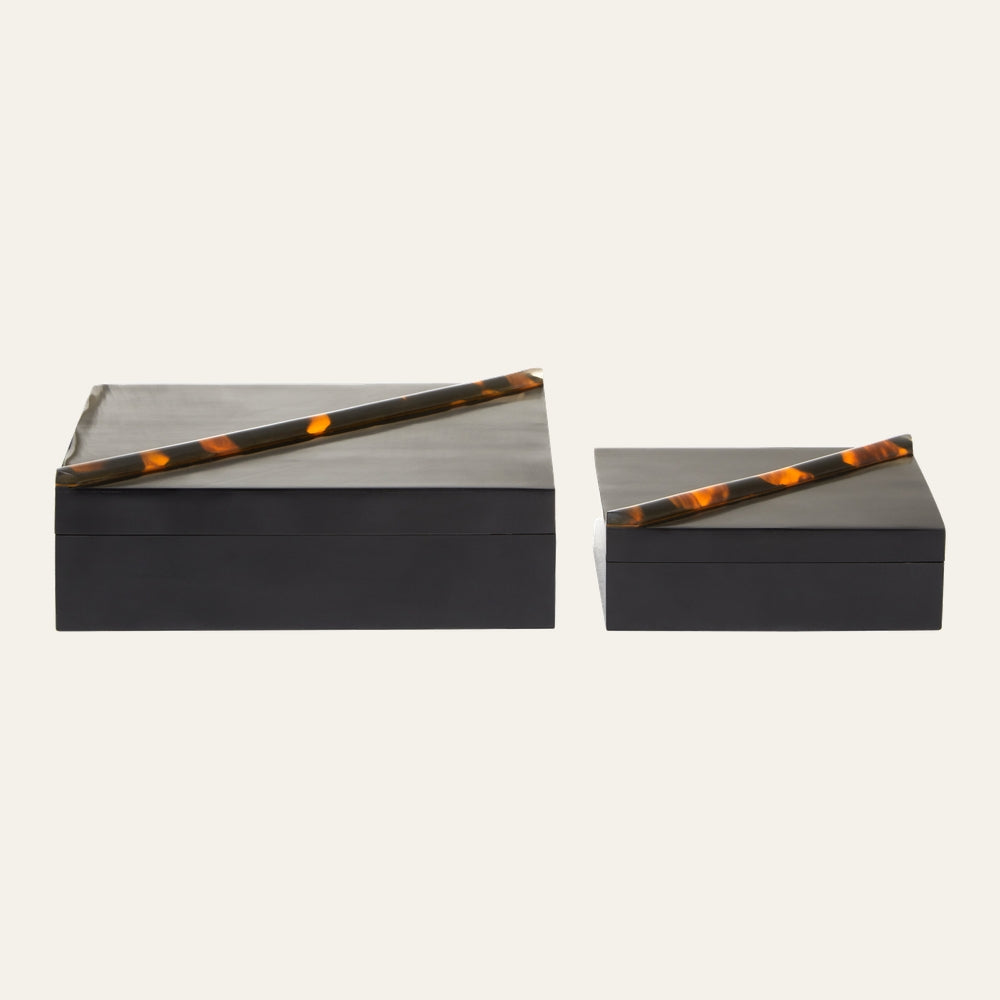 Elsi Tortoise Shell Trinket Box Set — two rectangular black trinket boxes with matte bases and dark lids topped with diagonal tortoise-shell patterned accent bars (large and small).