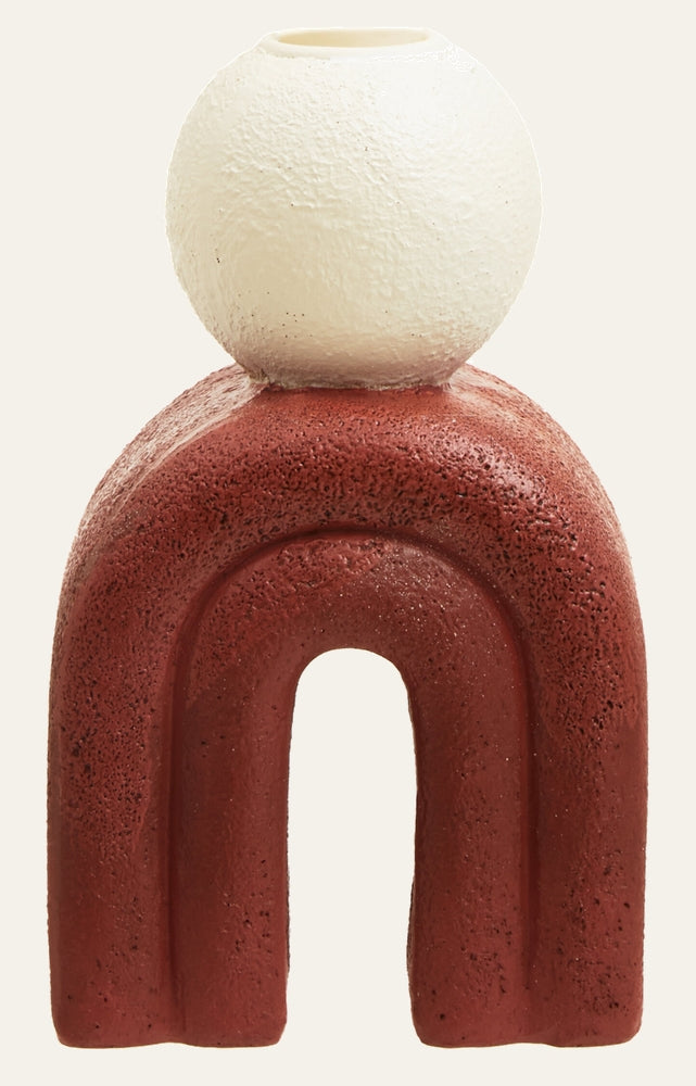 Eriya Candle Holder with a red terracotta-textured arch base and a white textured spherical candle cup on top.