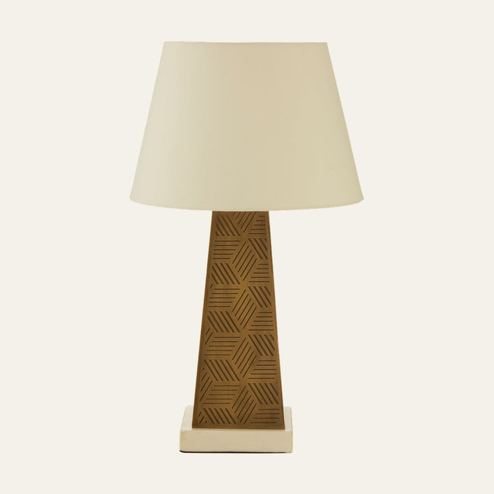 Esmira Marble Table Lamp with cream tapered fabric shade, patterned warm-brown carved geometric tapered column, and square cream marble base