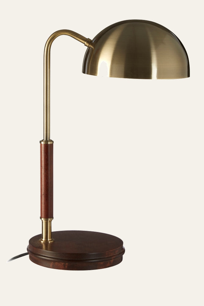 Evania Brass Wood Task Lamp with brushed brass dome shade, curved brass arm, dark wood column and round wooden base