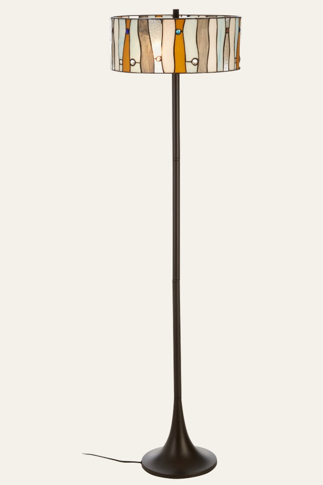 Evaya Floor Lamp with Tiffany-style stained glass drum shade in amber, cream and gray wavy panels with small colored glass accents, slender dark bronze metal pole and tapered round base
