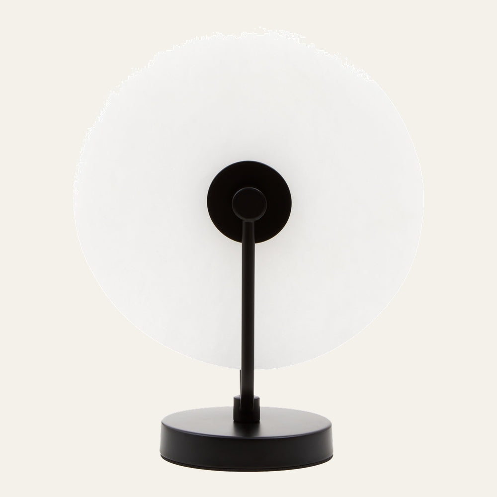 Evaya Marble Table Lamp — front view of large round white marble disc shade on a slim matte black metal stem and round black base.
