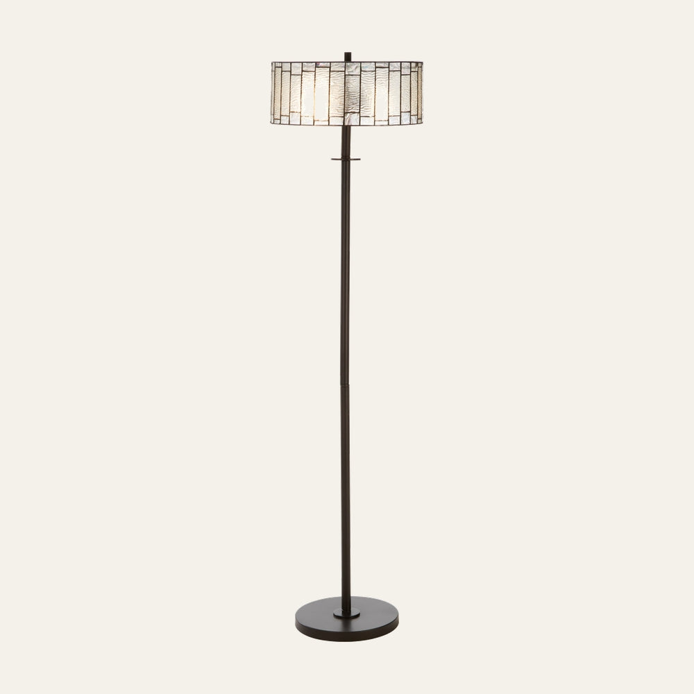 Evaya Open Frame Floor Lamp — dark bronze metal base and slim pole with a decorative stained-glass drum shade featuring rectangular textured glass panels and metal leading.
