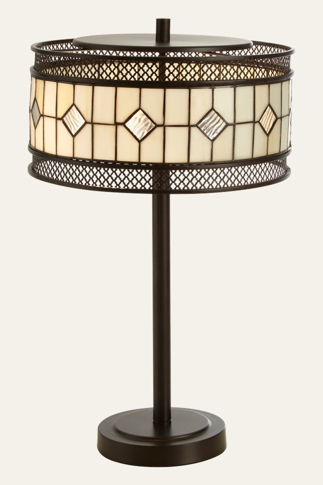 Evaya Table Lamp with dark bronze metal base and stem, round stained-glass drum shade in cream panels with diamond-shaped textured glass accents and pierced lattice metal trim