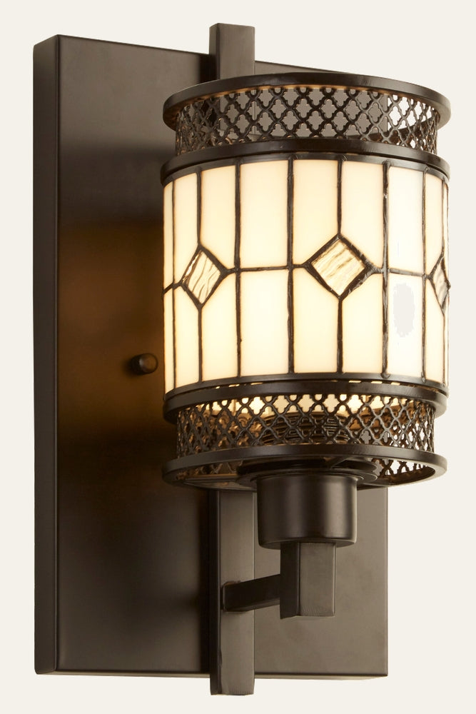 Evaya Wall Light with rectangular dark bronze backplate and short arm supporting a cylindrical cream stained-glass shade with diamond glass accents and decorative metal lattice trim.