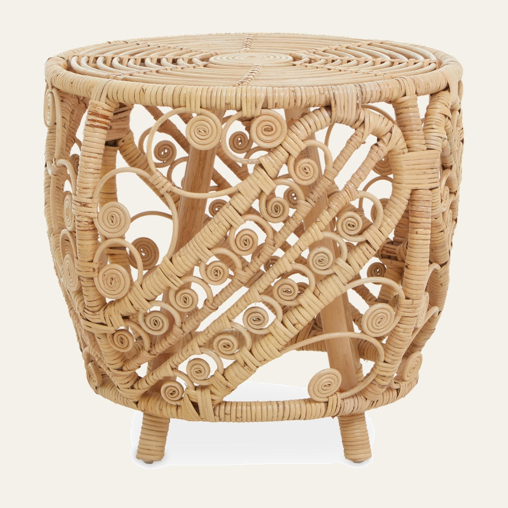 Evena Rattan Side Table — round natural rattan side table with woven circular top and openwork barrel-shaped base featuring diagonal spiral swirls and short wrapped rattan legs