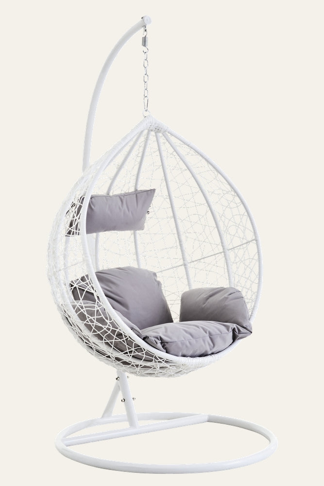 Evira Rattan Effect Hanging Chair — white rattan-effect egg-shaped hanging chair on a white metal stand with grey seat and back cushions.