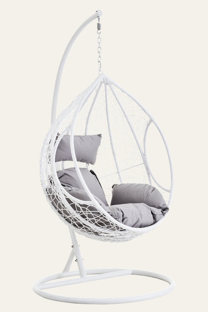 Evira White Rattan Grey Hanging Chair, white woven rattan teardrop frame with grey seat and head cushions, suspended from white metal stand with chain and spring