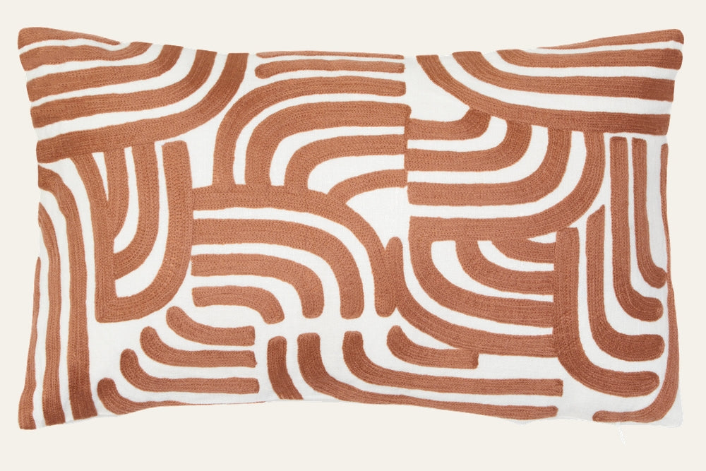 Ezelle Cushion | Ozella Cushion — rectangular white cushion with raised rust-brown curved geometric embroidered pattern
