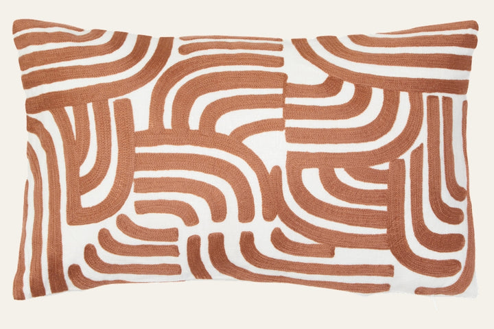 Ezelle Cushion | Ozella Cushion — rectangular white cushion with raised rust-brown curved geometric embroidered pattern