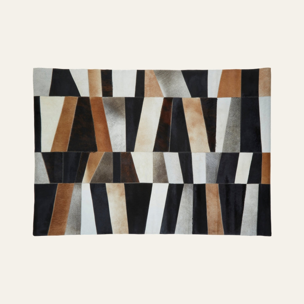 Ezelle Geometric Leather Rug with stitched patchwork trapezoid panels in black, brown, tan, cream and gray leather