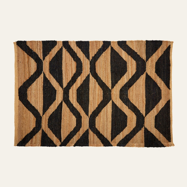 Ezelle Hemp Large Rug — rectangular woven hemp rug in natural tan with bold black geometric diamond-and-wave pattern