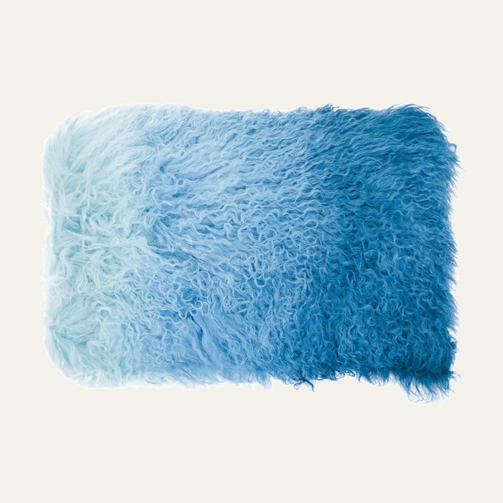 Ezelle Rectangular Cushion — rectangular cushion with long curly fur-like pile in ombré blues, fading from pale sky to deep ocean blue