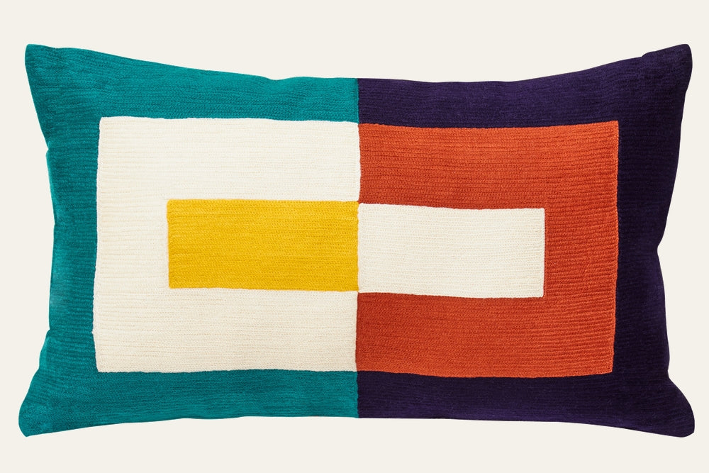 Ezelle Rectangular Fabric Cushion — rectangular woven fabric cushion with bold geometric color-block pattern in teal, cream, mustard yellow, burnt orange and deep purple