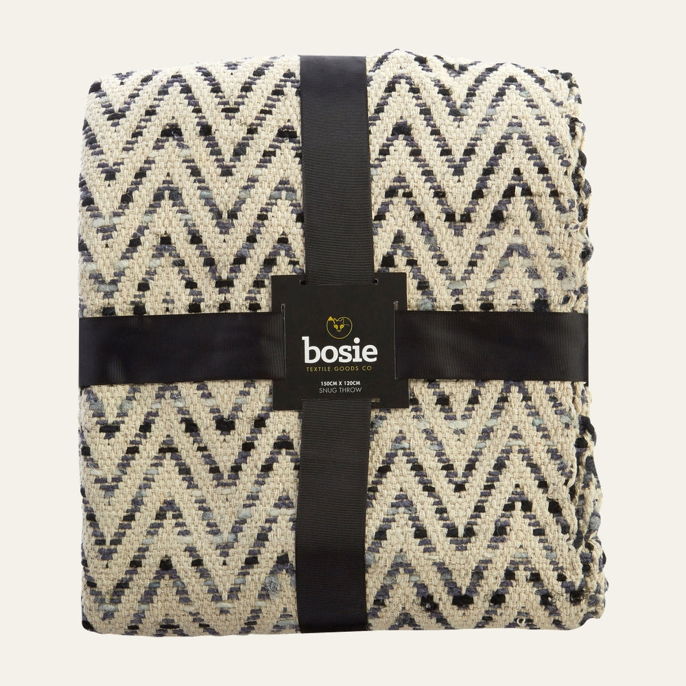 Ezelle Throw folded with black ribbon, cream and navy chevron woven texture and Bosie label.