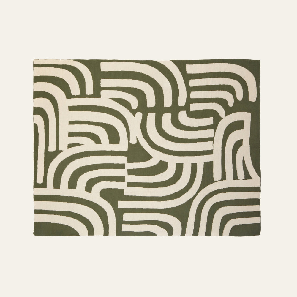 Ezelle Throw | Ozella Throw — rectangular throw laid flat with olive green background and cream abstract curved stripe arch pattern
