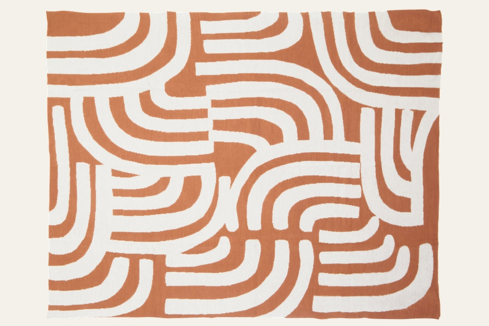 Ezelle Throw | Ozella Throw — rectangular rust and white throw blanket with bold abstract curved-arch pattern, shown laid flat