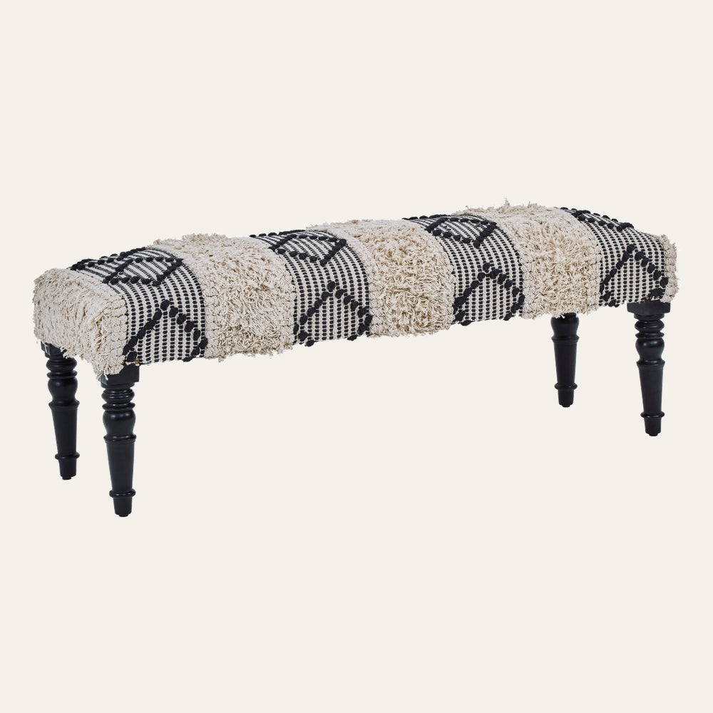 Fenlor Bench — rectangular upholstered bench with alternating cream shaggy tufted and black-and-cream woven diamond stripes, on turned black wooden legs