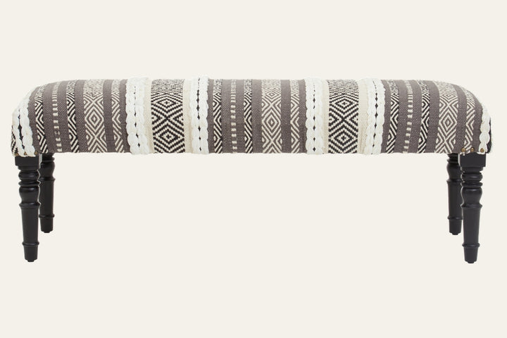 Fenlor Open Frame Bench with gray-and-cream woven geometric striped upholstery, braided cream accents, and turned black wooden legs.