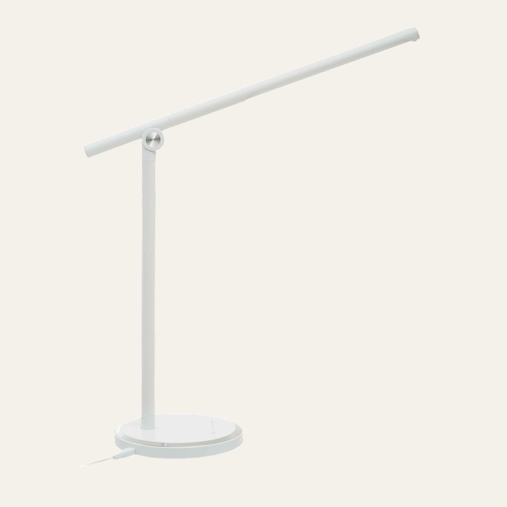 Galven Round Table Lamp — minimalist white round-base table lamp with slim vertical stem and adjustable horizontal tube arm, silver pivot accent.