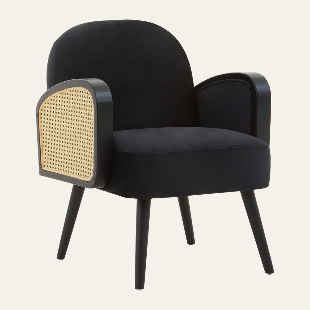 Halvor Velvet Rattan Wood Accent Chair in black velvet with rounded back, black wood tapered legs and curved armrests featuring natural rattan cane panels.