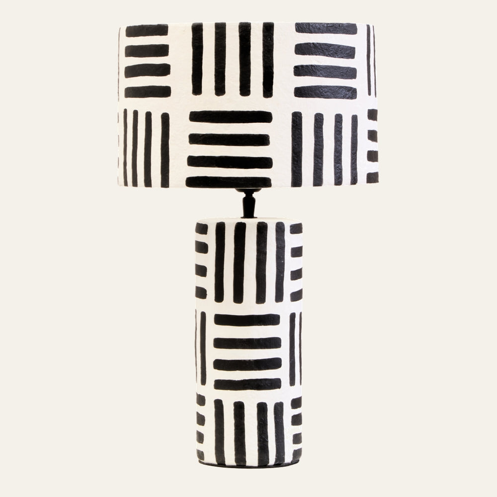 Irdan Table Lamp with cylindrical white painted base and matching drum shade featuring bold black hand-painted horizontal and vertical stripe pattern