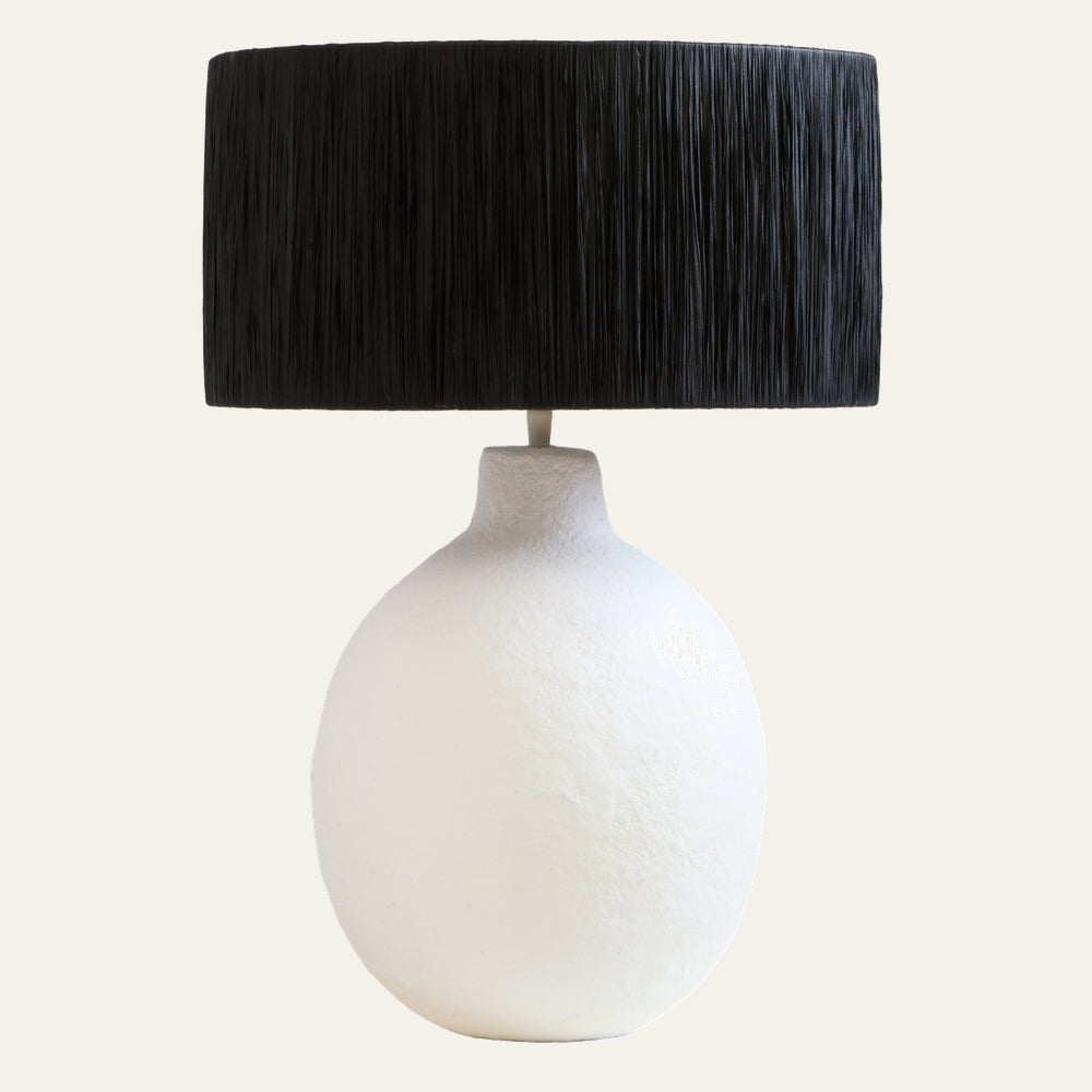 Irdan Table Lamp with matte white textured oval base and black vertical-strand drum shade