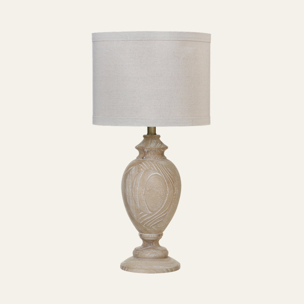 Irella Wooden Table Lamp with carved light-wood base showing visible woodgrain texture and a natural linen drum shade.