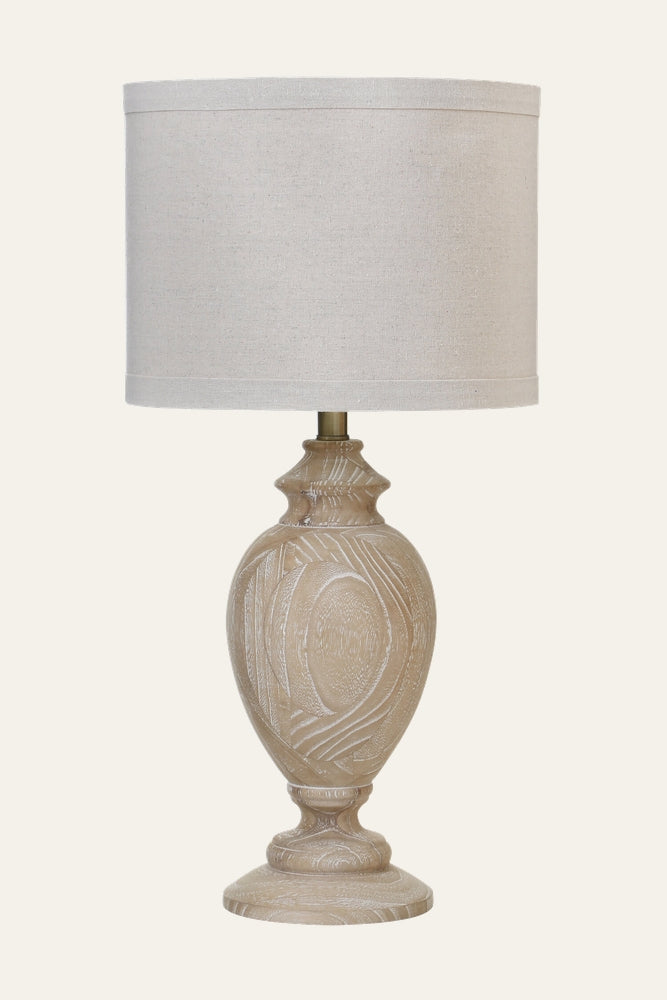 Irella Wooden Table Lamp with whitewashed carved wooden urn base on round pedestal and natural linen drum drum shade
