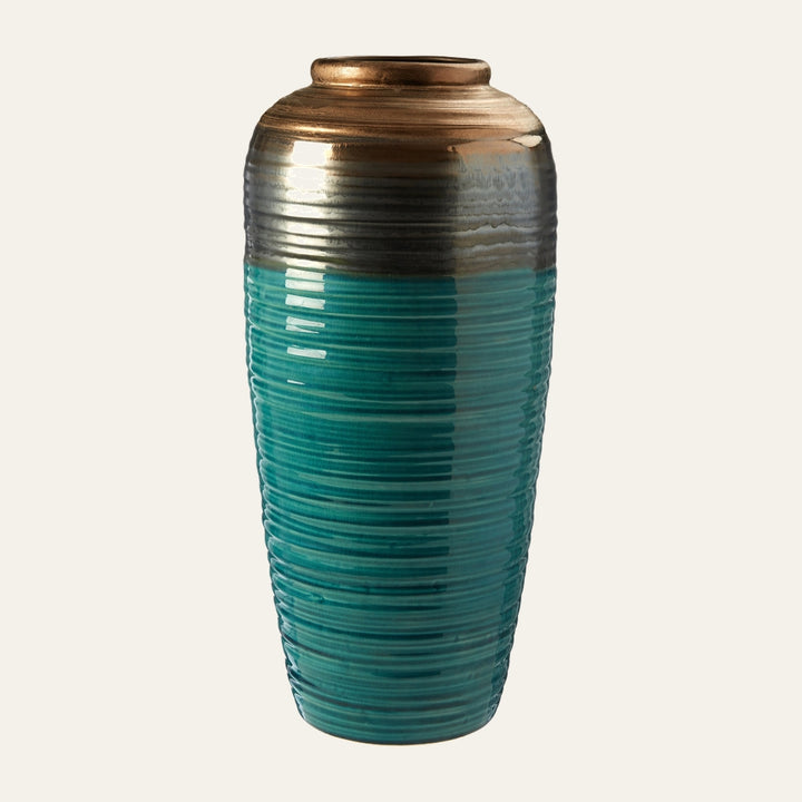 Irisa Ribbed Ceramic Vase — tall tapered ceramic vase with horizontal ribbed texture, glossy teal lower body fading to gray and metallic bronze near the narrow neck