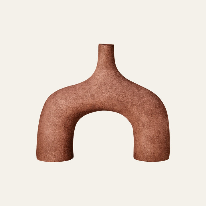 Isola Textured Abstract Vase — arch-shaped terracotta form with a narrow top neck and rough textured matte finish