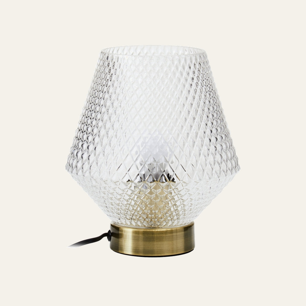 Lysara Table Lamp with faceted clear diamond-pattern glass shade, brushed brass round base, visible bulb and black cord