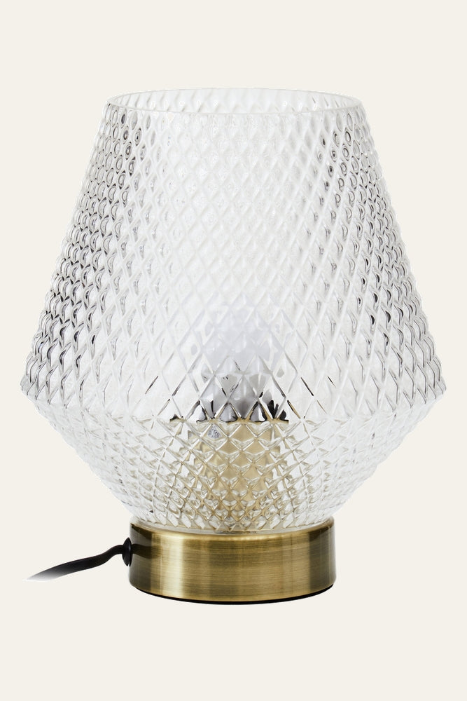 Lysara Table Lamp with clear diamond‑pattern textured glass shade, brass‑finish metal base, visible bulb inside and black power cord