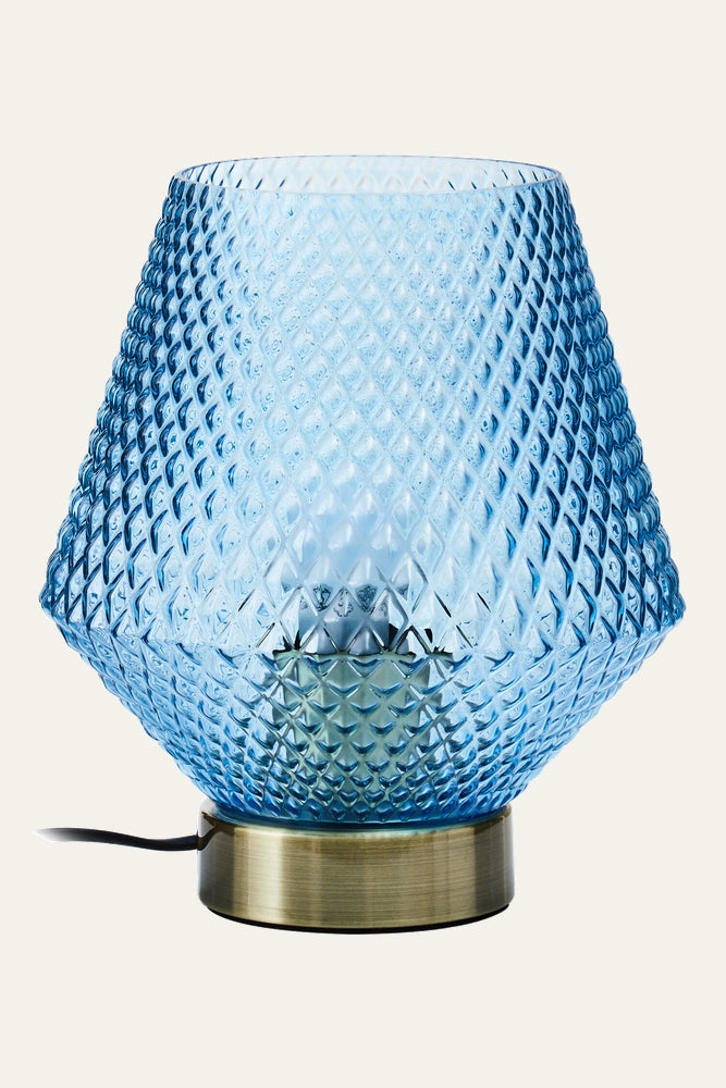 Lysara Table Lamp with blue diamond-textured glass shade, visible interior bulb, brass-tone metal base and black power cord