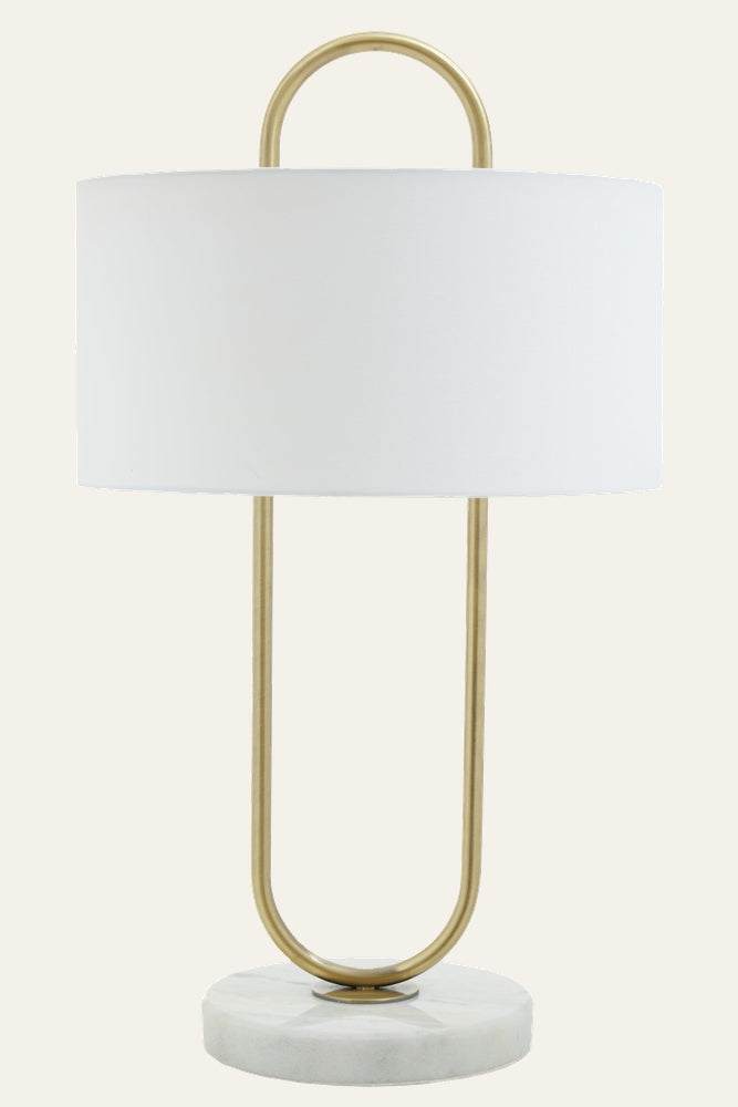 Mavie Fabric Shade Table Lamp with white fabric drum shade, brass-finish U-shaped metal frame and round white marble base.