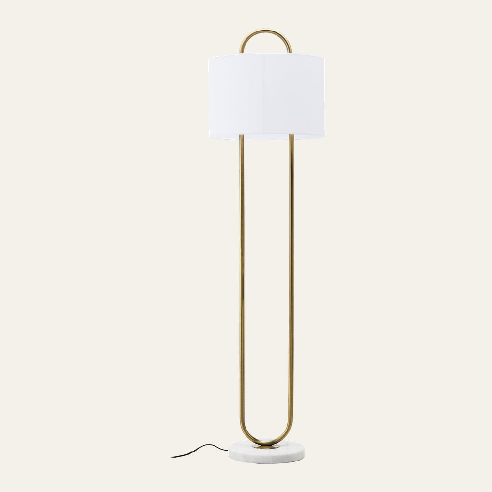 Mavie Gold Floor Lamp — slim U-shaped gold metal frame with white drum shade and round white marble base, visible black power cord