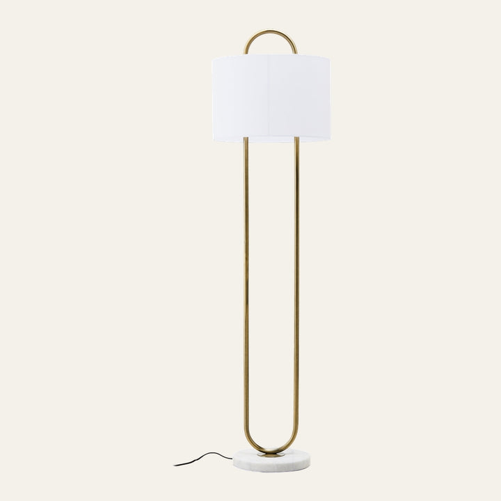 Mavie Gold Floor Lamp — slim U-shaped gold metal frame with white drum shade and round white marble base, visible black power cord
