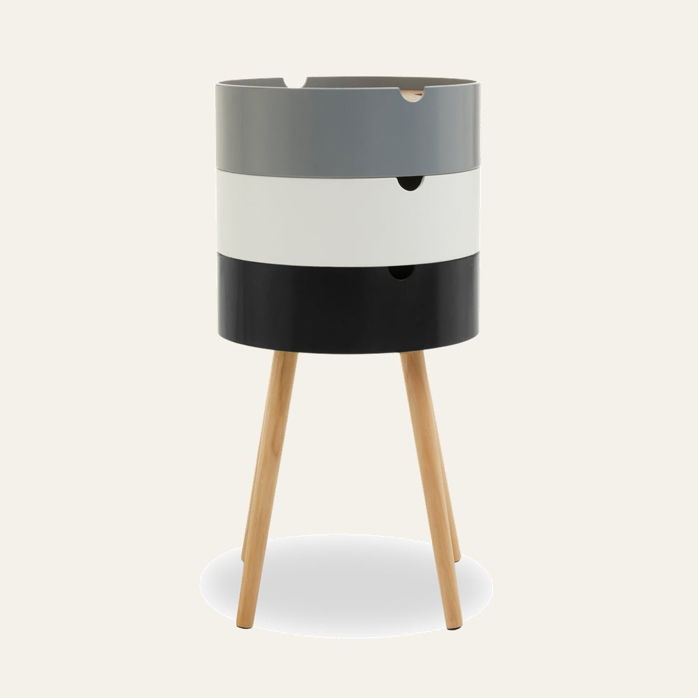 Mirel Three Tier Side Table with three stacked cylindrical tiers in gray, white, and black with notch cutout handles, on natural wood tripod legs