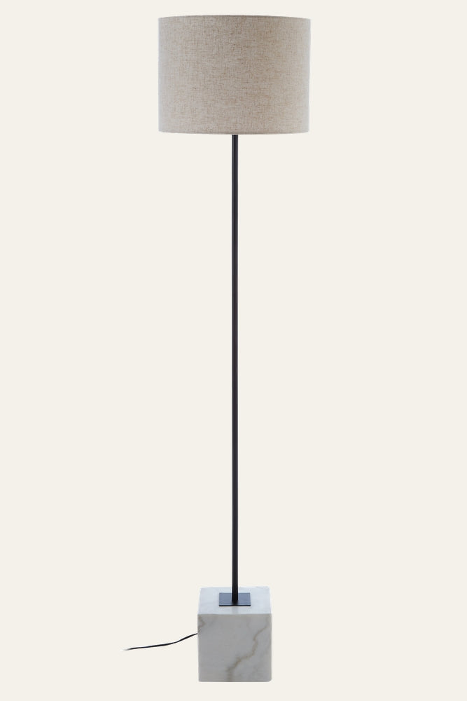 Miro Marble Base Floor Lamp — beige fabric drum shade, slim black metal stem, white marble cube base with subtle veining.