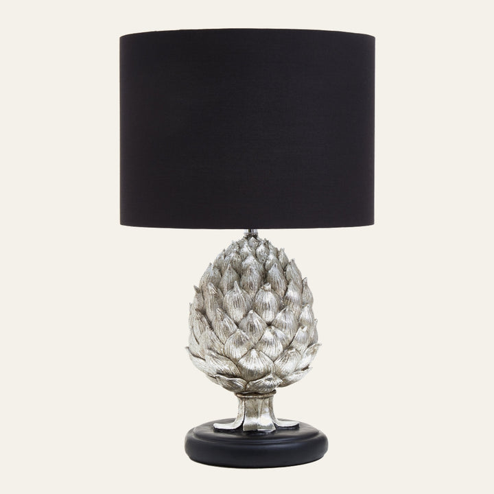 Orelia Artichoke Table Lamp with silver-finished artichoke-shaped base, black round base and black fabric drum shade